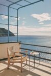 F-Chair Outdoor Lounge Chair with distinctive paddle-shaped armrests and relaxed incline for garden settings