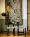 Daumiller Side Chair by GUBI featuring curved wooden backrest, natural rush seat, and sustainable pine construction.