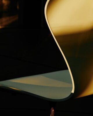 Close-up of the iridescent gold-toned rainbow base on Fritz Hansen's limited edition Series 7 chair designed by Arne Jacobsen