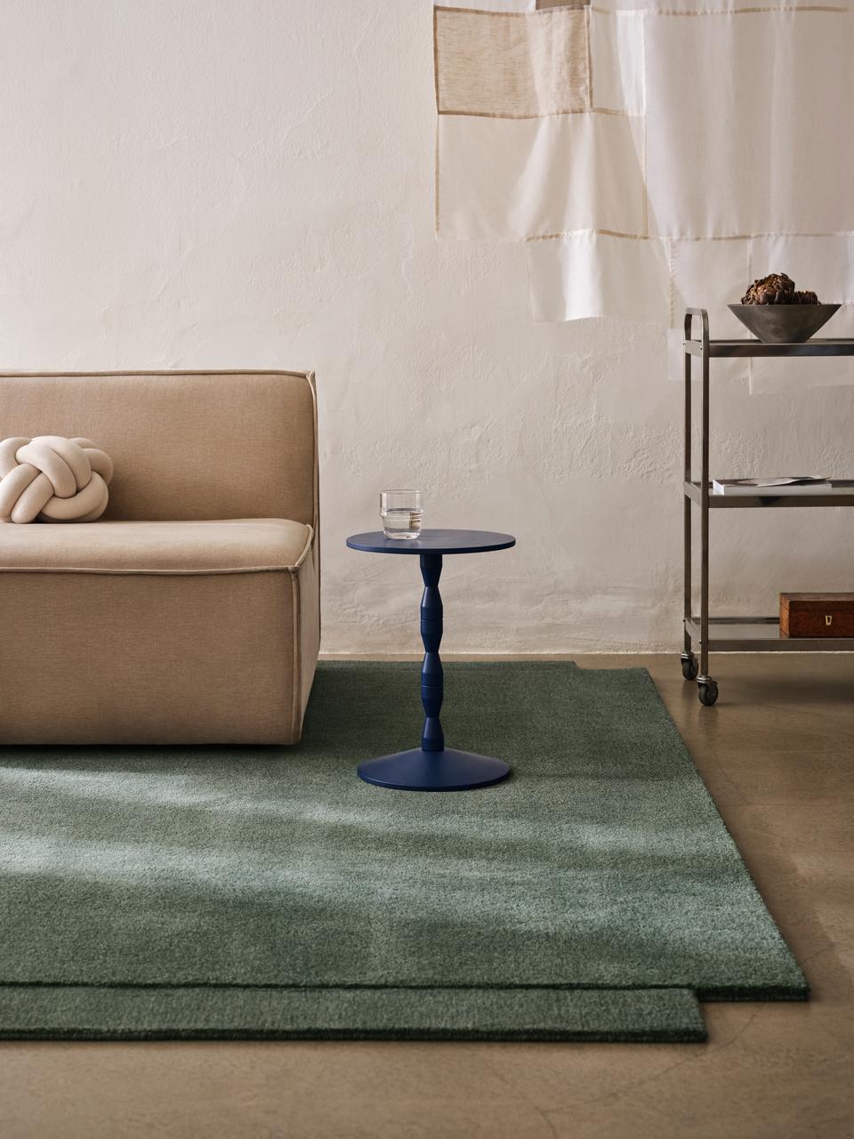 Matti Klenell's red Pedestal Table by Design House Stockholm in a living room setting displaying decorative objects