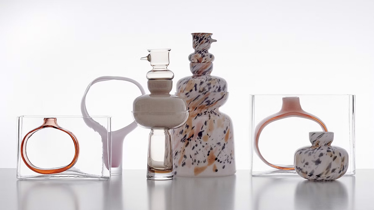 Multiple glass sculptures by Matti Klenell displayed in gallery setting showing varied forms and transparency