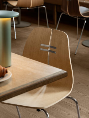 PK3 chair by Poul Kjærholm showing laminated wood veneer seat and steel tube frame construction for Fritz Hansen