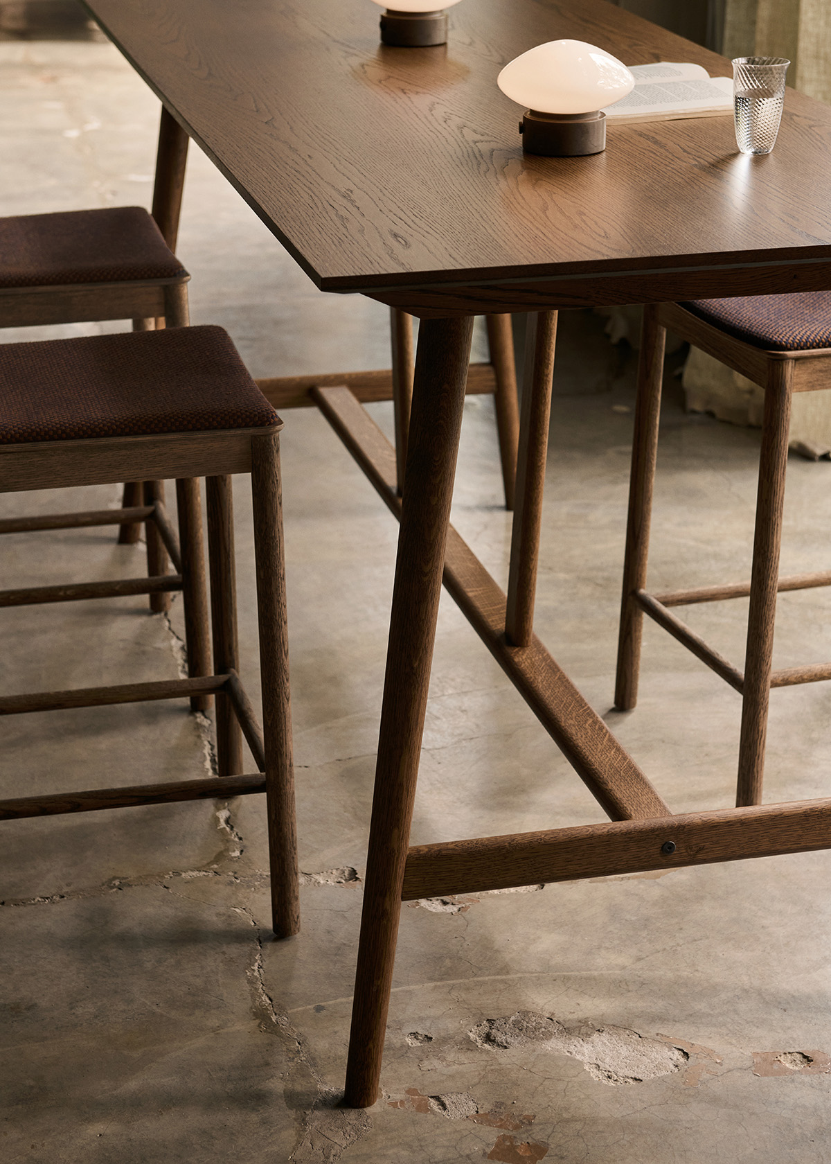 In Between bar and counter tables by Sami Kallio featuring bridge-inspired oak construction multiple heights