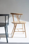 YES Chair by Björn Dahlström showing rounded backrest seamlessly transitioning into armrests with minimal slat design